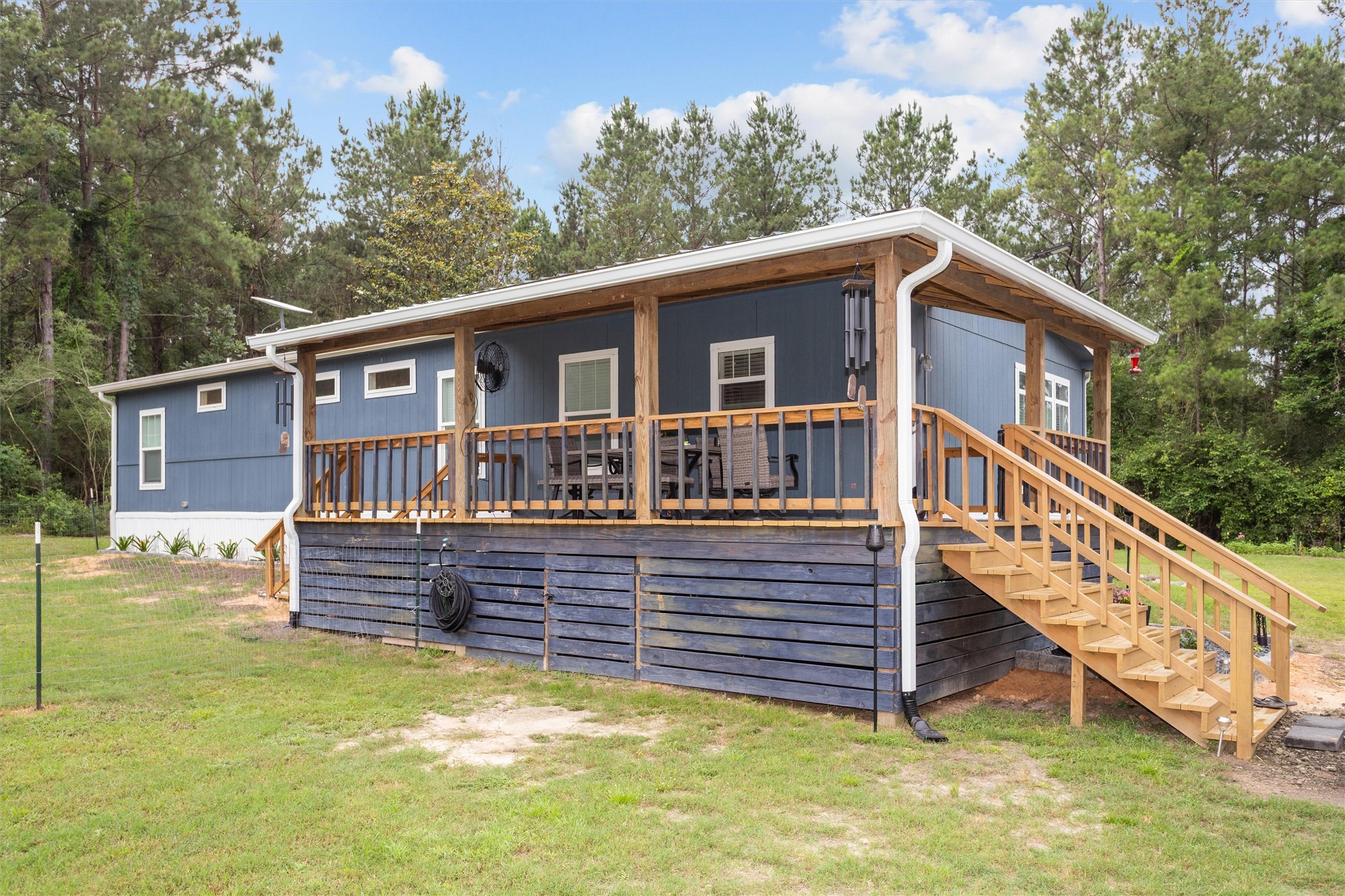 275 County Road 3215 Colmesneil, TX 75938 - Photo 8 of 34 a view of a house with wooden deck and a backyard