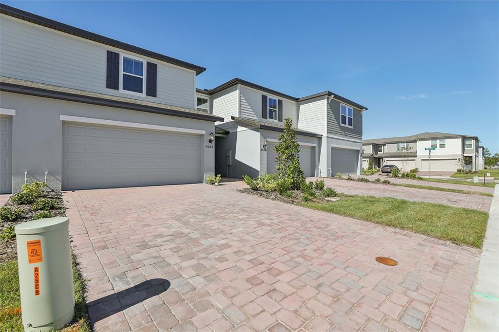 4264 Ranch House Road St. Cloud, FL 34772 - Photo 6 of 74 a front view of a house with a yard and garage