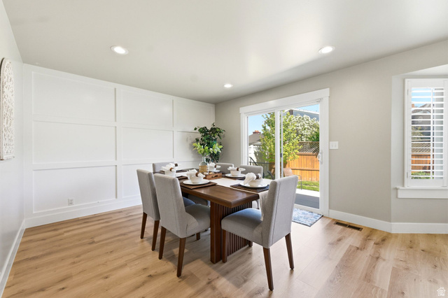 1405 Vintry Lane Murray, UT 84121 - Photo 12 of 44 Dining area with wood-finish flooring, recessed lighting, and a decorative paneled accent wall