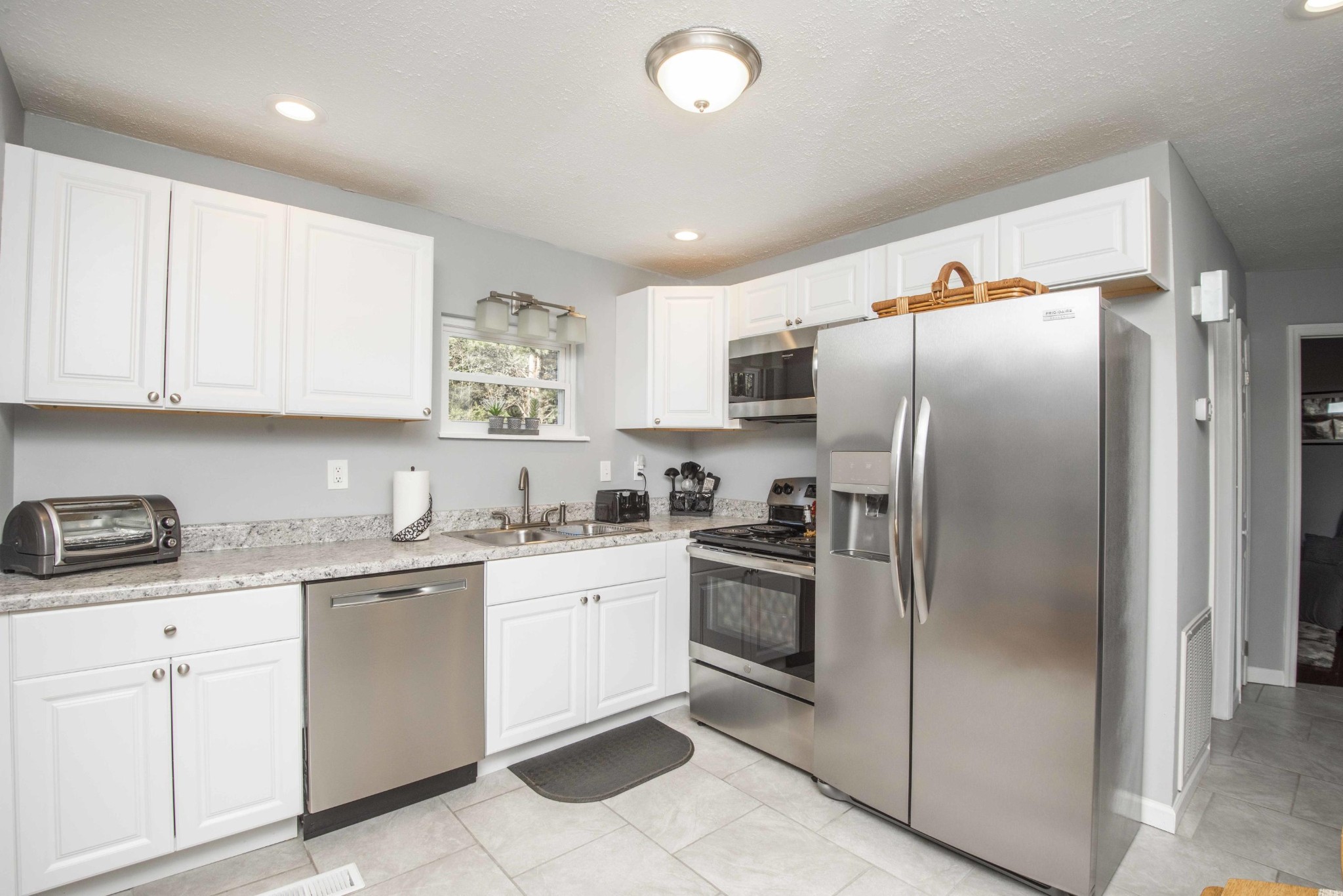 581 Stephens Road Greenback, TN 37742 - Photo 9 of 30 a kitchen with stainless steel appliances granite countertop a refrigerator sink and cabinets