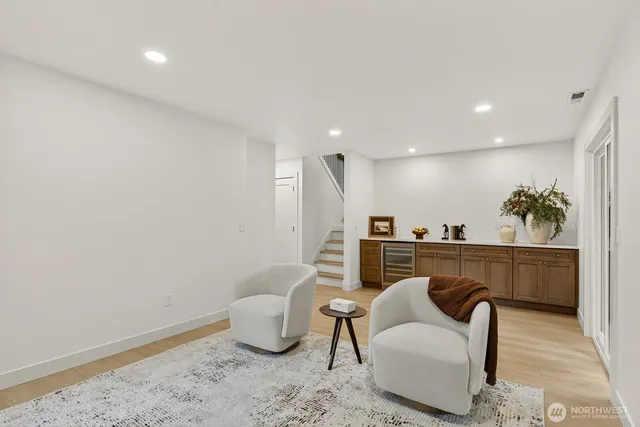 a living room with furniture a couch and a potted plant