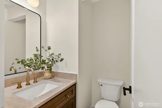 a bathroom with a sink toilet and mirror