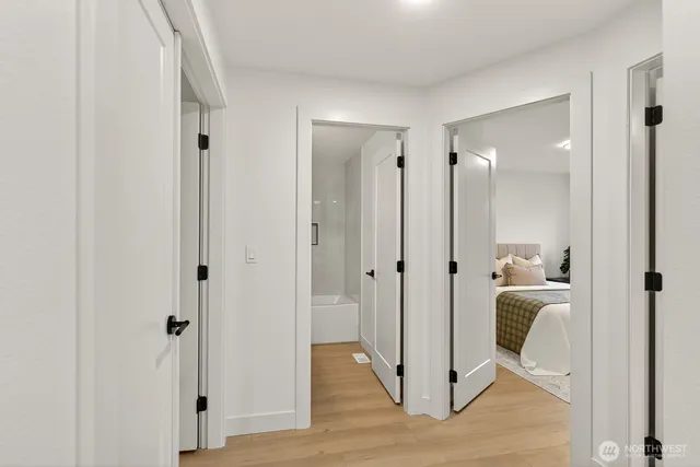 a view of a hallway with wooden floor and closet