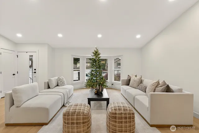 a living room with furniture potted plant and a window