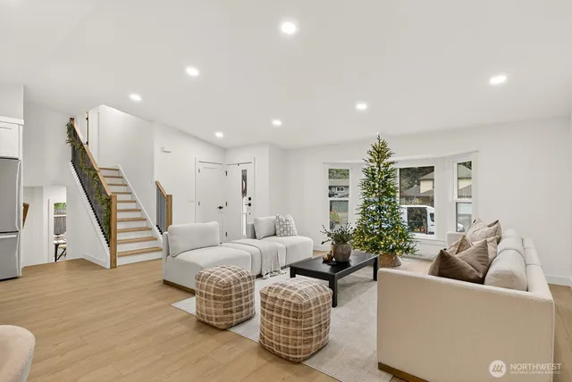 a living room with furniture and a wooden floor