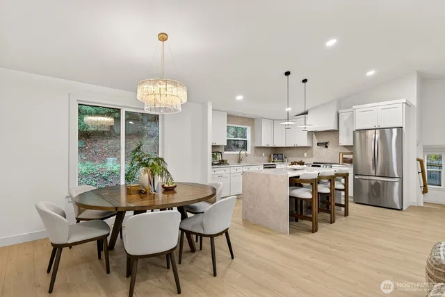 a dining room with furniture a chandelier and wooden floor
