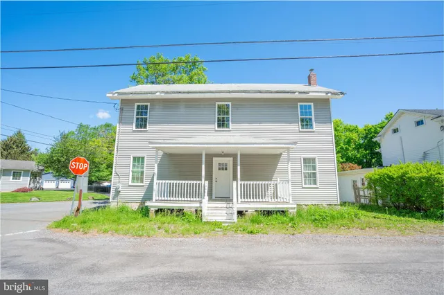 a front view of a house with a garden and plants