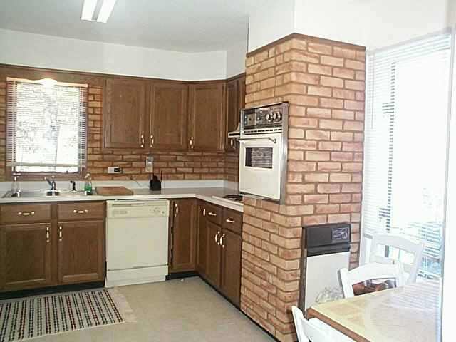 2780 West Longhollow Road Elizabeth, IL 61028 - Photo 2 of 9 a kitchen with a sink cabinets and window