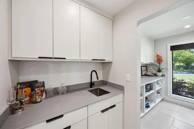 a kitchen with a sink and cabinets