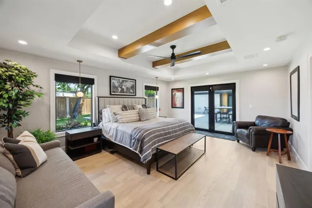 a spacious bedroom with a bed and glass walk in closet