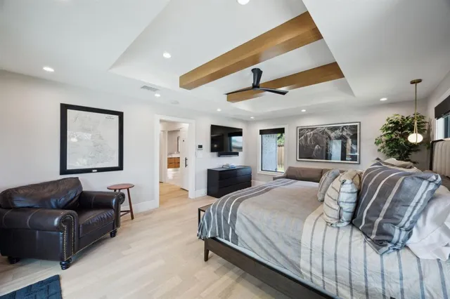 a spacious bedroom with a large bed and a couch