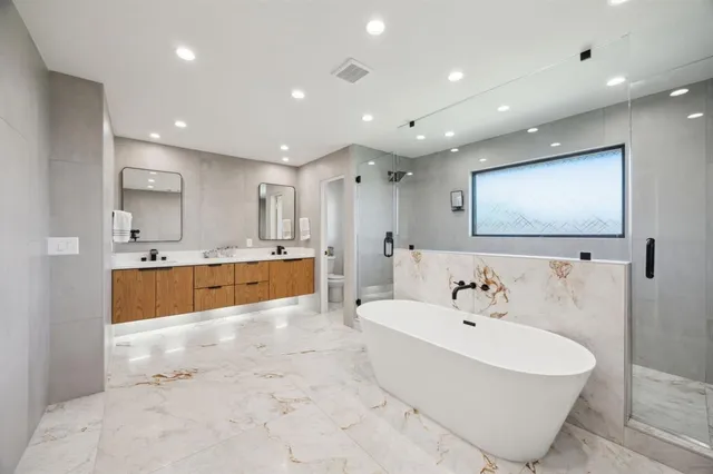 a large white kitchen with a white table and chairs