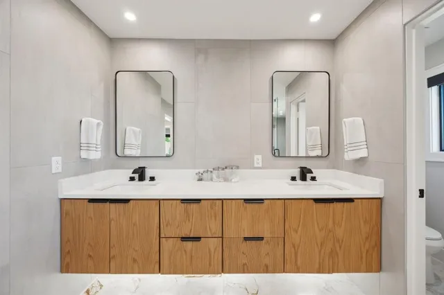 a bathroom with a double vanity sink and a mirror