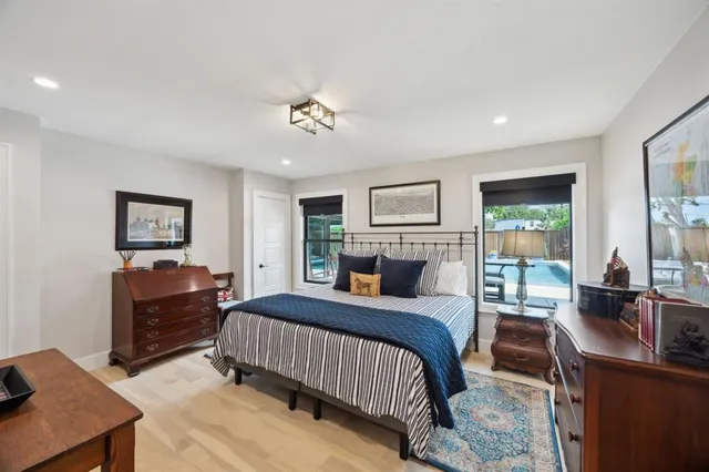 a bedroom with a bed a couch and dresser