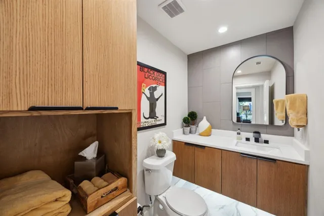 a bathroom with a toilet sink and mirror