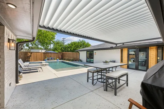 a view of a patio with table and chairs and potted plants