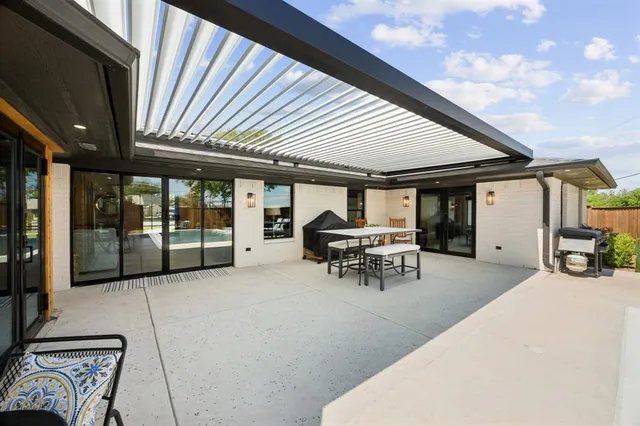 a view of a house with backyard and sitting area
