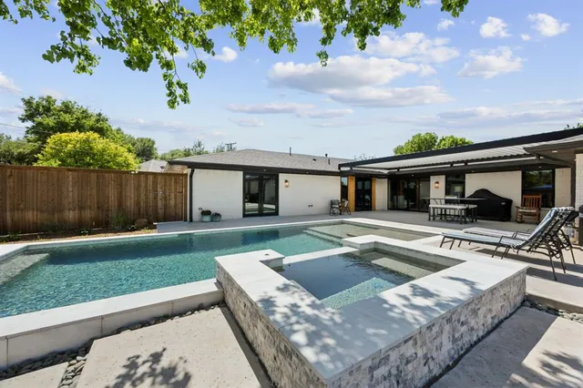 a view of swimming pool and outdoor seating