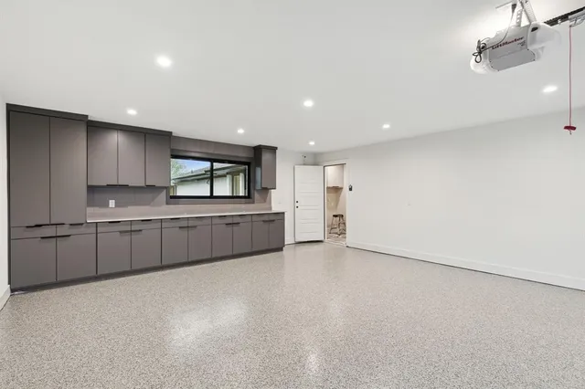 a view of a patio with table and chairs under an umbrella