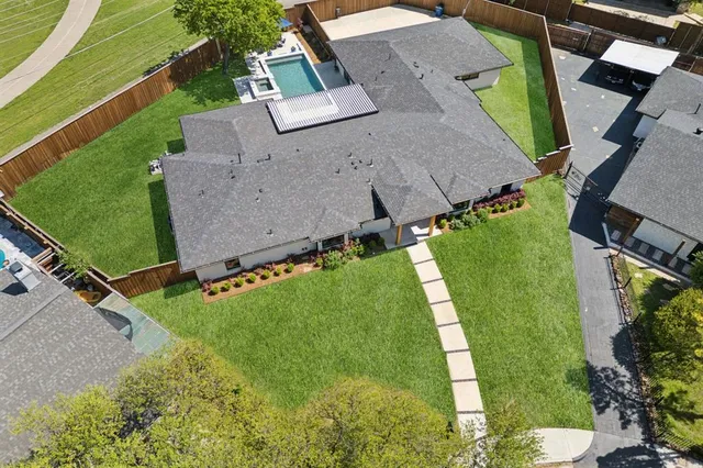 an aerial view of a house with garden space and street view