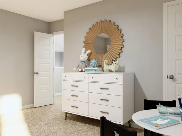 a room with a mirror a dresser and a mirror