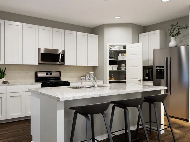 a kitchen with stainless steel appliances granite countertop a stove a sink dishwasher and a refrigerator with wooden cabinets