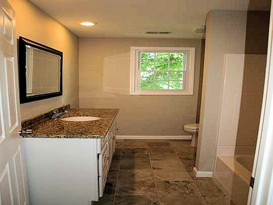 Spacious main bathroom with porcelain tile floor, 60 inch vanity with granite countertop with under-mount bowl and tub/shower combination!