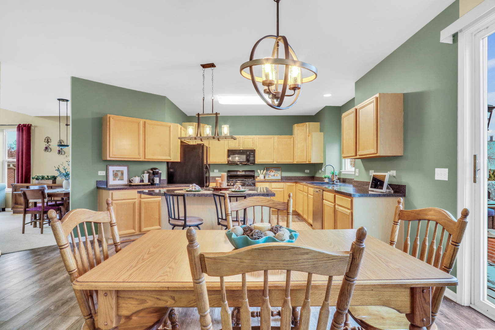 77 Bridle Path Drive Lindenhurst, IL 60046 - Photo 12 of 52 a view of a dining room with furniture wooden floor and chandelier