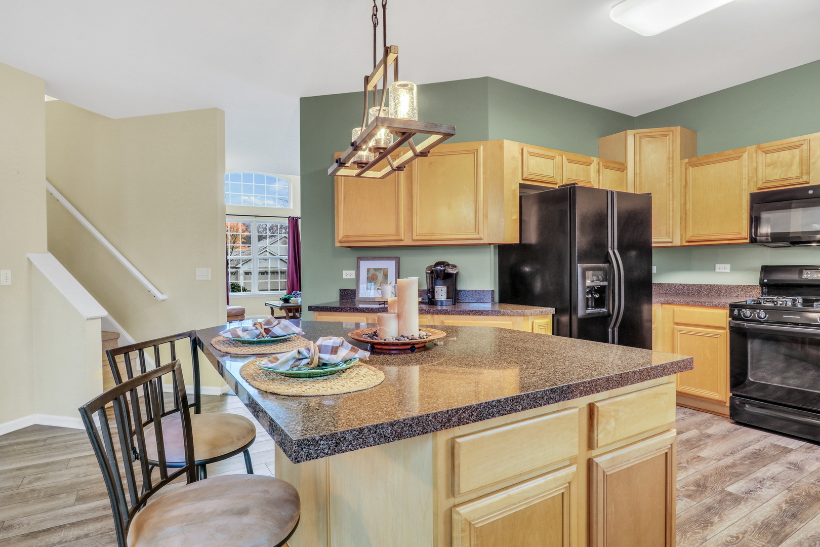 77 Bridle Path Drive Lindenhurst, IL 60046 - Photo 14 of 52 a kitchen with stainless steel appliances granite countertop a stove a refrigerator a kitchen island a dining table and chairs