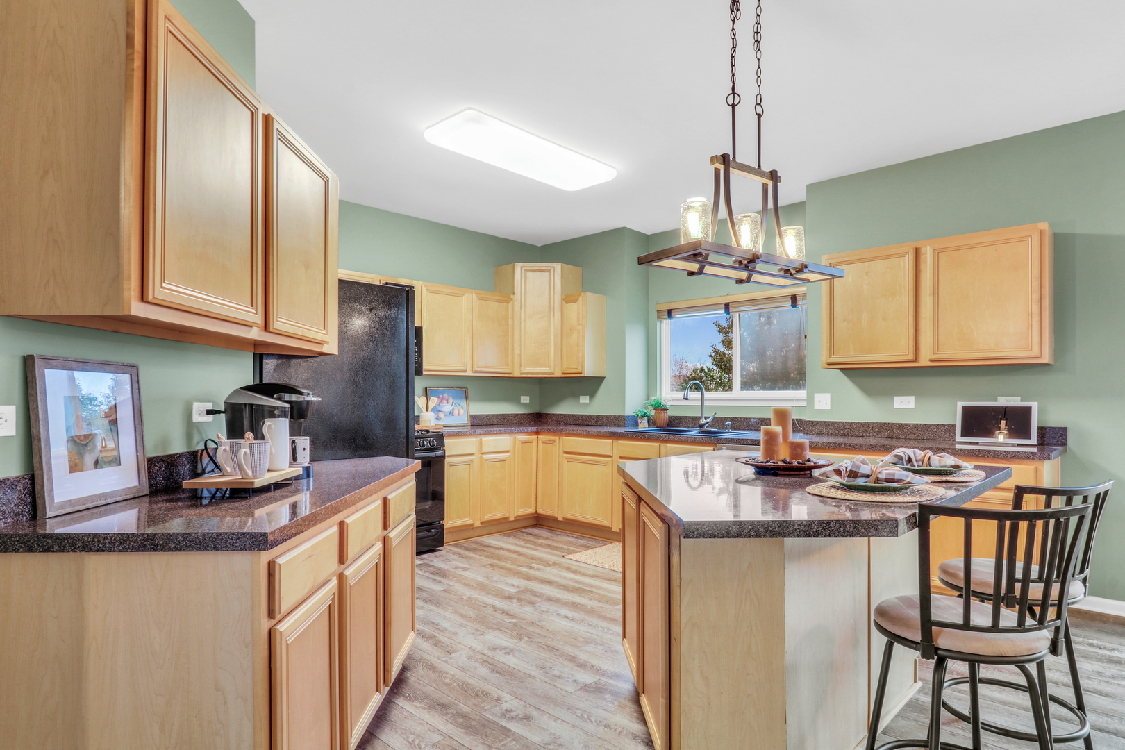 77 Bridle Path Drive Lindenhurst, IL 60046 - Photo 15 of 52 a kitchen with stainless steel appliances granite countertop a sink a stove a refrigerator cabinets and chairs