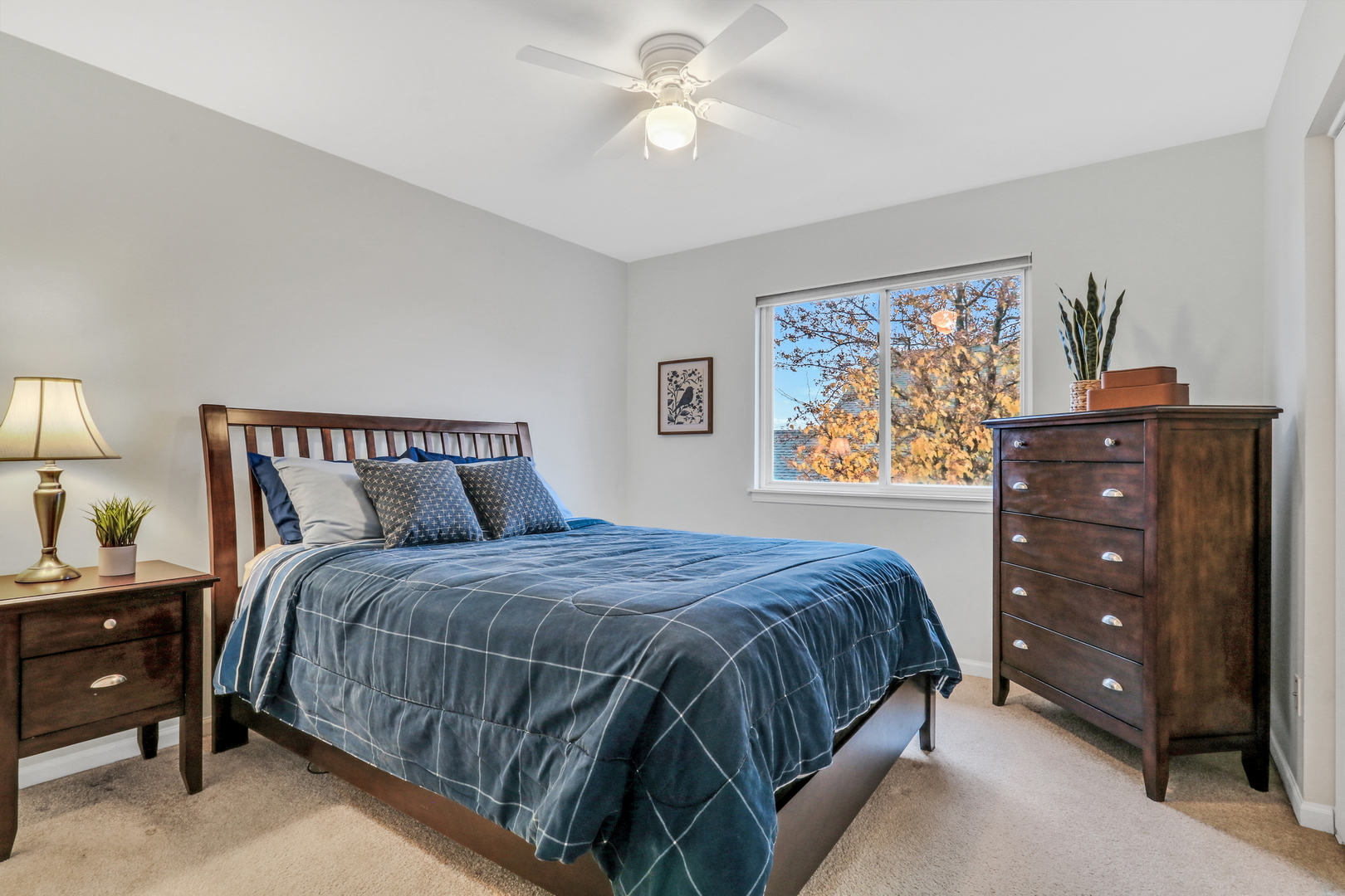 77 Bridle Path Drive Lindenhurst, IL 60046 - Photo 34 of 52 a bedroom with a bed and a chandelier