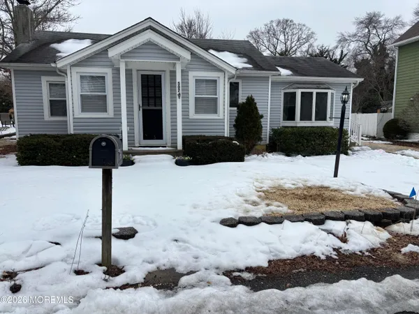 a front view of a house with yard covered in snow