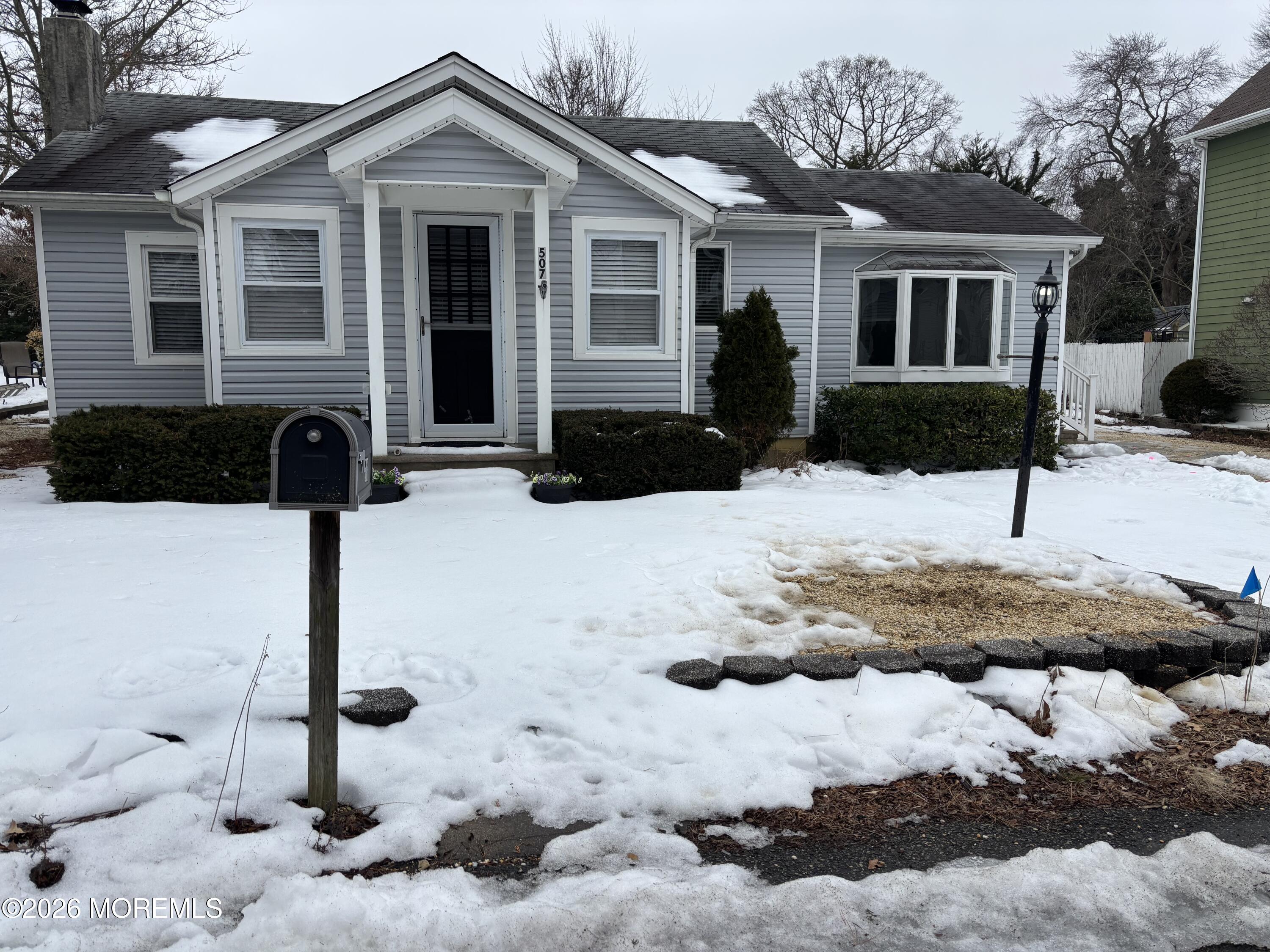 507 Riverside Drive South Brick, NJ 08723 - Photo 3 of 17 a front view of a house with yard covered in snow