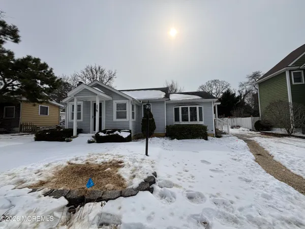 a front view of a house with a yard covered in snow