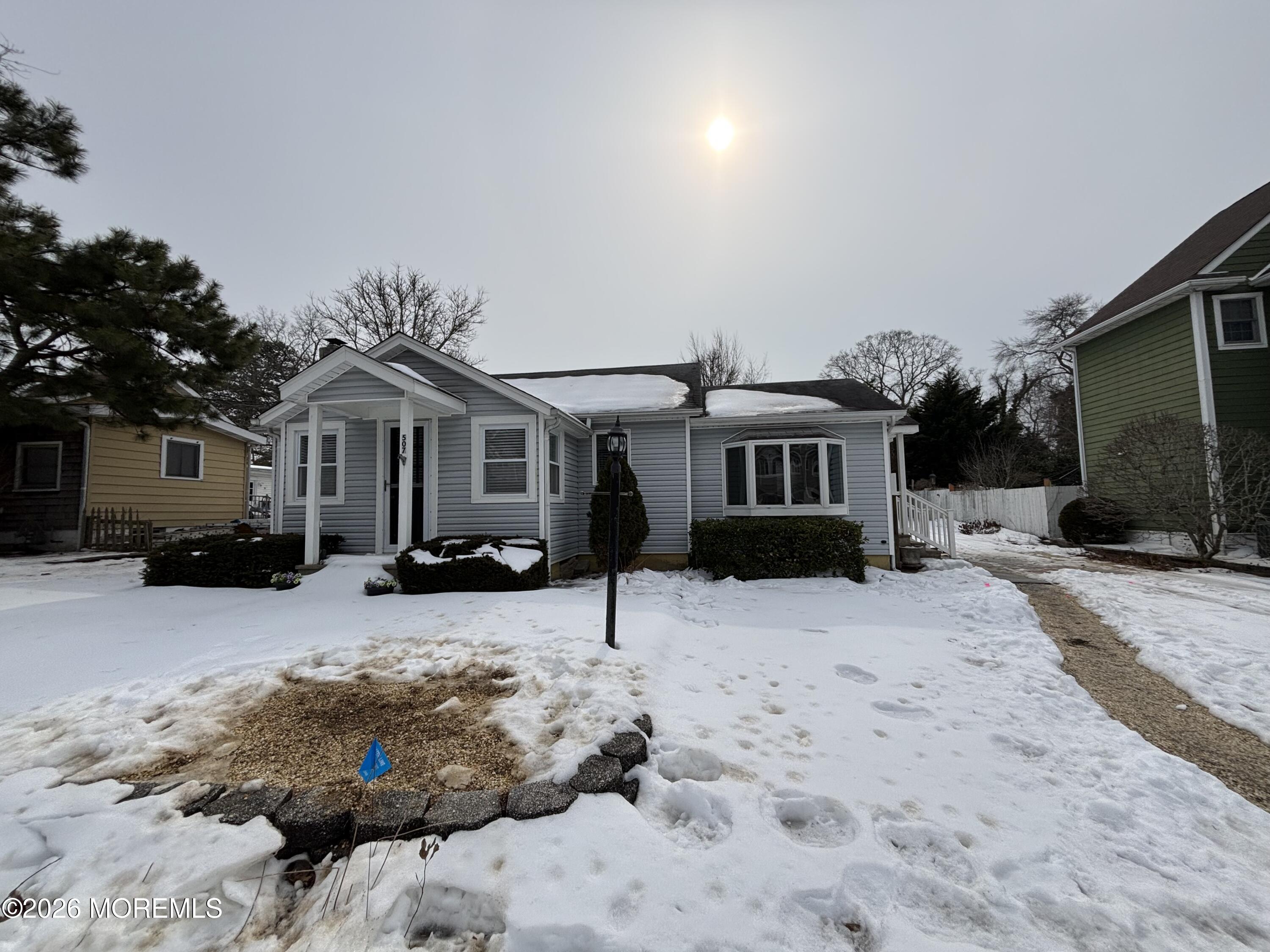 507 Riverside Drive South Brick, NJ 08723 - Photo 4 of 17 a front view of a house with a yard covered in snow