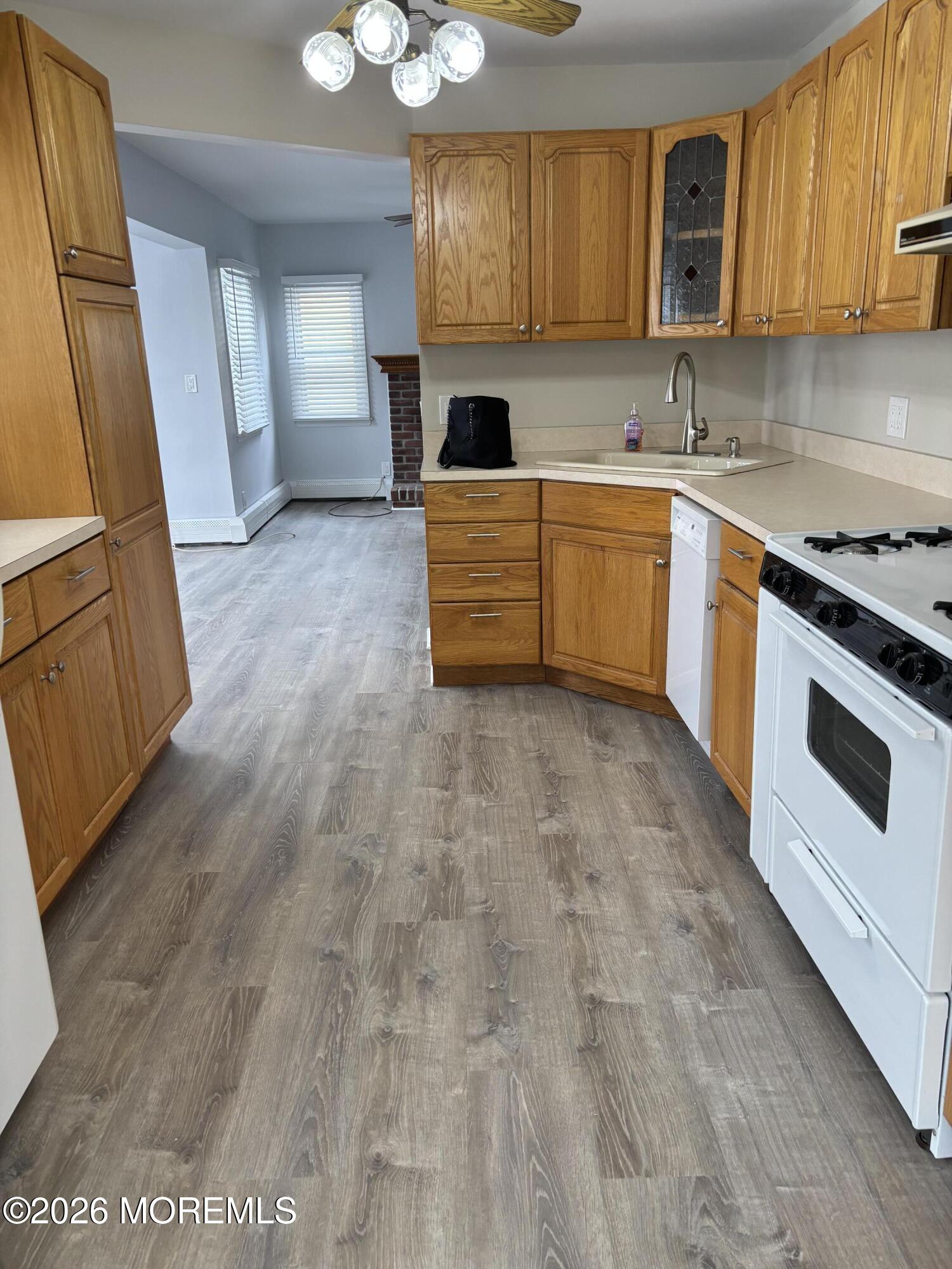 507 Riverside Drive South Brick, NJ 08723 - Photo 7 of 17 a kitchen with granite countertop a stove a sink and a microwave