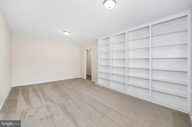 a view of an empty room with a white walls