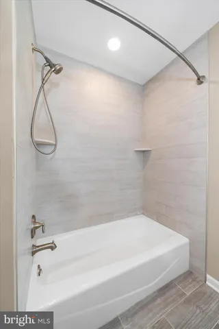 a bathroom with a bath tub with a shower