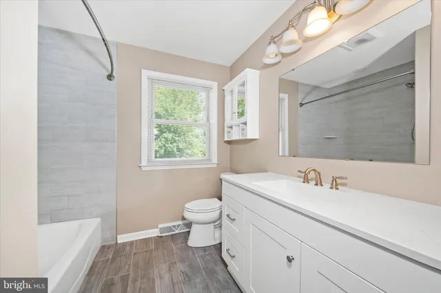 a bathroom with a sink toilet a mirror and shower