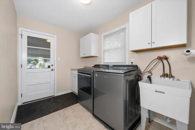 a kitchen with a refrigerator and white cabinets