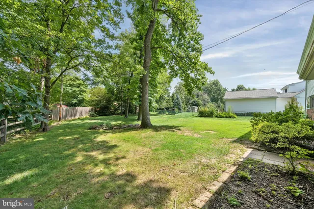a front view of a house with garden and swimming pool