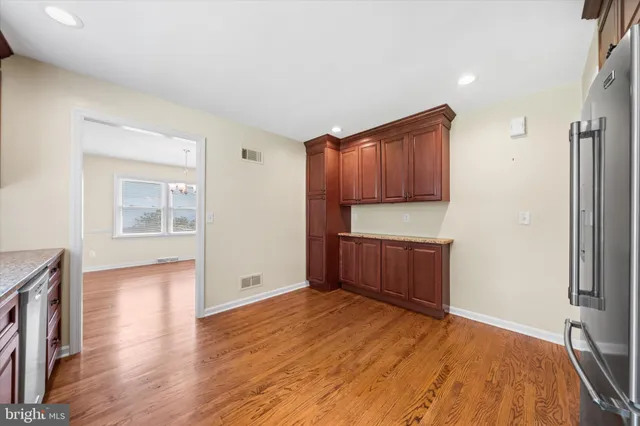 a kitchen with stainless steel appliances granite countertop a refrigerator and a sink