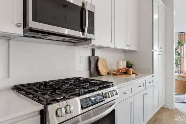a stove top oven sitting inside of a kitchen