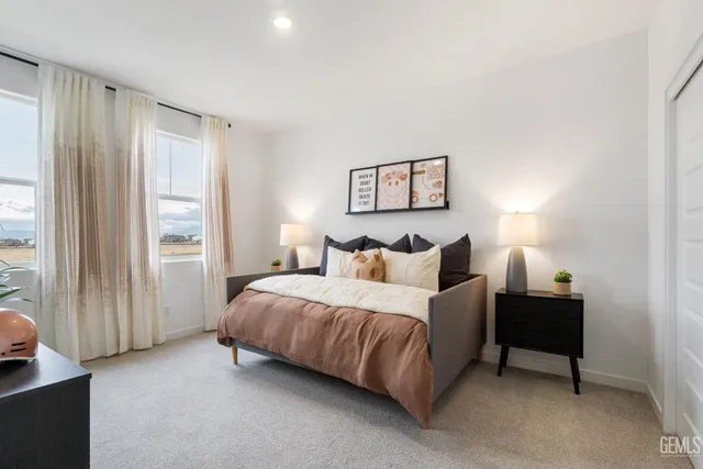 a spacious bedroom with a bed and a window