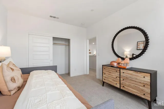 a bedroom with a bed and a mirror