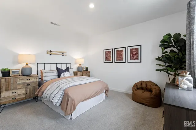a bedroom with a bed and a potted plant
