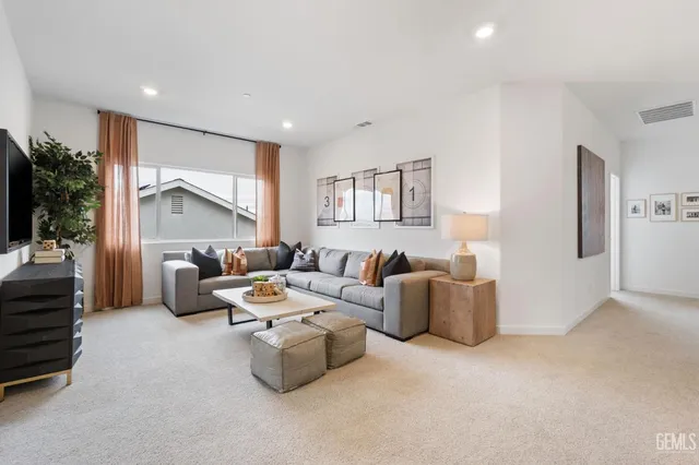 a living room with furniture and a potted plant