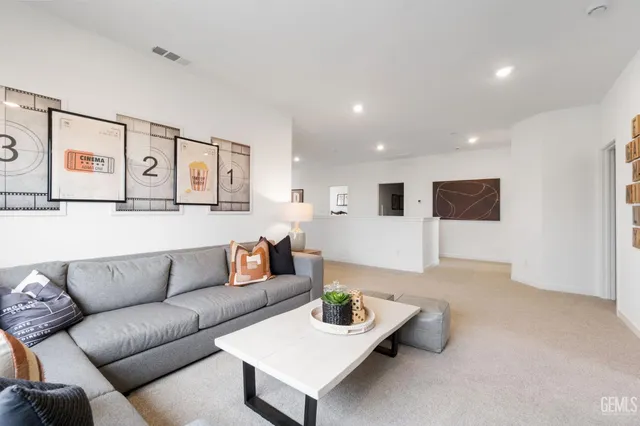 a living room with furniture and kitchen view