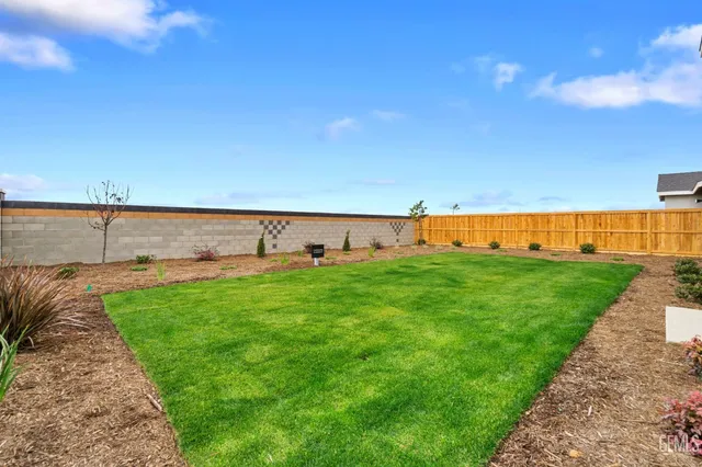 a view of a garden with lawn chairs
