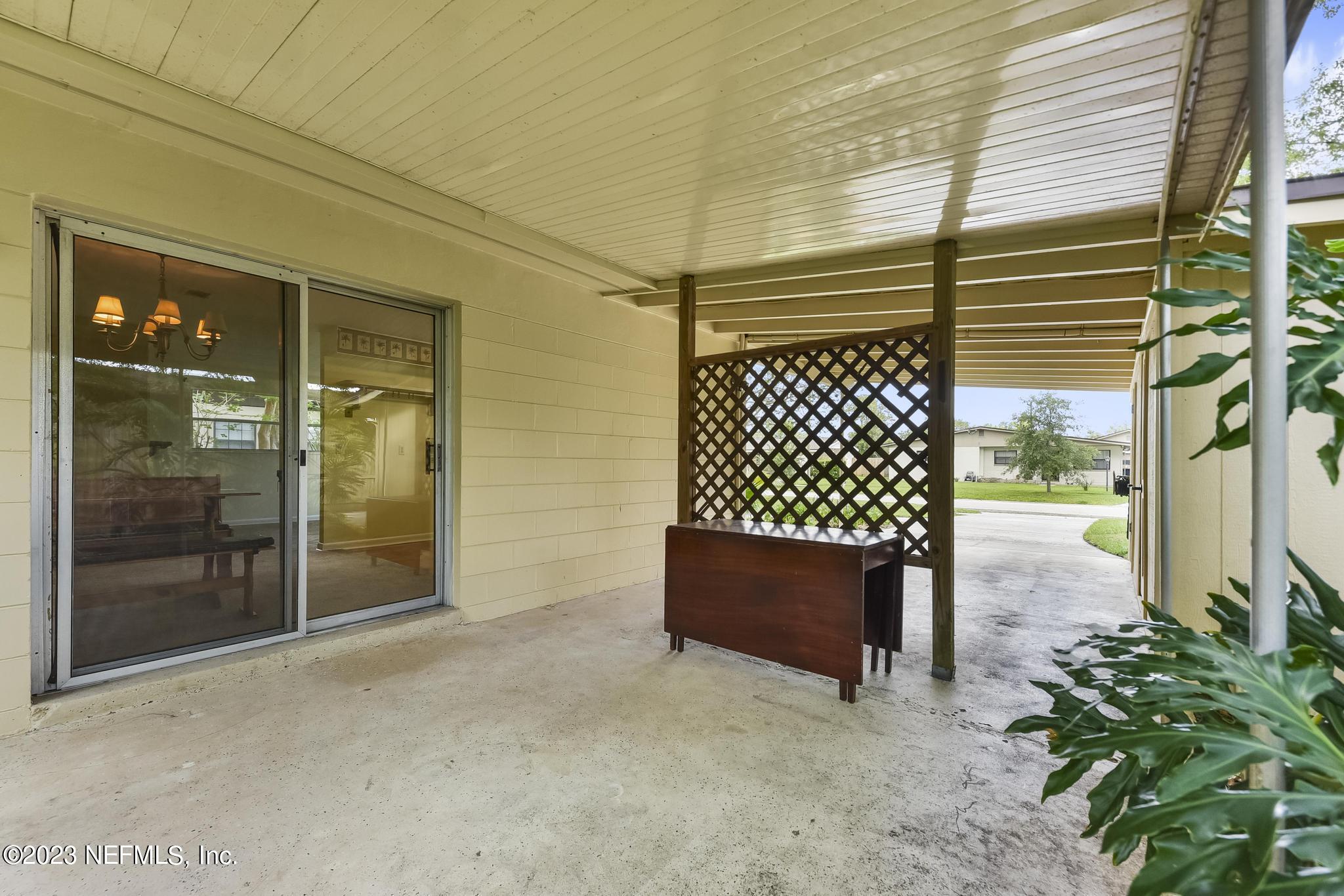 5627 Sabena Road Jacksonville, FL 32207 - Photo 19 of 22 a view of a porch with a table and chairs and wooden fence